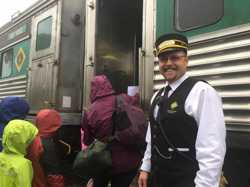 Maine Eastern Railroad conductor Ernie Vannah of Waldoboro stays all smiles as passengers in Wiscasset join the passenger service’s final northbound run Oct. 25. SUSAN JOHNS/Wiscasset Newspaper