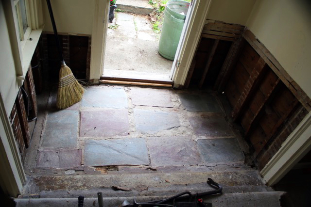 After pulling up carpet and plywood in the entryway, the couple found slate tiles, which were removed, and will be eventually be laid back in. Courtesy of Pamela Logan