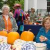 Betty Applin, left, of Wiscasset sells pumpkins and apples with Anne Harris of Westport Island on October 5, at the First Congregational Church of Wiscasset's Oktoberfest. SUSAN JOHNS/Wiscasset Newspaper