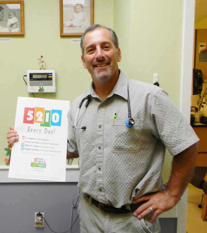 Dr. Steven Feder is one of 200 pediatricians in Maine to receive an award for a childhood obesity prevention program, among other initiatives. The 5-2-1-0 program is so popular that many states have sought to use the campaign. Feder stands in his office at the John F. Andrews Medical Arts building in Boothbay Harbor, holding one of the catchy posters distributed throughout the nation to promote healthy families. DIANE RANDLETT/Boothbay Register Dr. Steven Feder is one of 200 pediatricians in Maine to receive an award for a childhood obesity prevention program, among other initiatives. The 5-2-1-0 program is so popular that many states have sought to use the campaign. Feder stands in his office at the John F. Andrews Medical Arts building in Boothbay Harbor, holding one of the catchy posters distributed throughout the nation to promote healthy families. DIANE RANDLETT/Boothbay Register