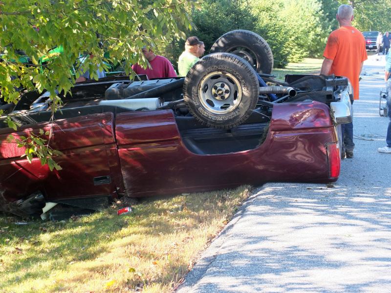 Emergency personnel begin working to get the driver out of the overturned truck. KATHY ONORATO/Wiscasset Newspaper Emergency personnel begin working to get the driver out of the overturned truck. KATHY ONORATO/Wiscasset Newspaper