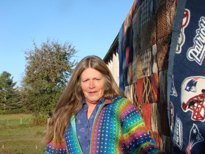 Rhonda Hamlin, pictured the morning after the October 16 earthquake, was in her Wiscasset home working on this Patriots quilt when she felt the quake's vibrations. SUSAN JOHNS/Wiscasset Newspaper Rhonda Hamlin, pictured the morning after the October 16 earthquake, was in her Wiscasset home working on this Patriots quilt when she felt the quake's vibrations. SUSAN JOHNS/Wiscasset Newspaper