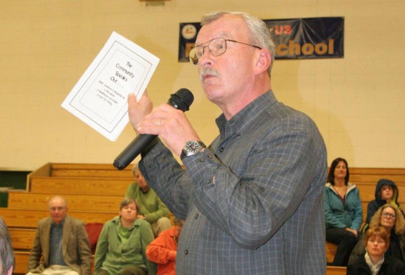 Mike Pander urges people to pick up a copy of Patty Seybold's publication of interviews done with St. Andrews Hospital patients. Below: Task force attorney Julius Ciembroniewicz tells the audience he hopes talks with Maine Health and Lincoln County Healthcare will lead to solutions before legal actions are considered; iVantage consultant Ralph Gabarro outlines the objectives of the firm's study of St. Andrews Hospital and the communities it serves. KEVIN BURNHAM/Boothbay Register Mike Pander urges people to pick up a copy of Patty Seybold's publication of interviews done with St. Andrews Hospital patients. KEVIN BURNHAM/Boothbay Register