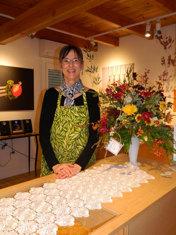 Owner of the Peapod Jewelry Ronna Lugosch prepares for her guests at the Business After Hours event November 1. CHARLOTTE BOYNTON/Wiscasset Newspaper. Below: this 14k gold pendent of a dove holding a peapod in his mouth is a sample of the jewelry designed by Lugosch. Courtesy of Peapod Jewelry Owner of the Peapod Jewelry Ronna Lugosch prepares for her guests at the Business After Hours event November 1. CHARLOTTE BOYNTON/Wiscasset Newspaper