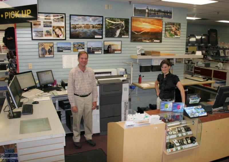 Conall O’Brien, left, and Leisha MacDougall stand in the photo processing area at Video Loft. The new, all-digital photo processing equipment speeds up delivery and photographs are sharper than when the business used chemicals to print photographs. KEVIN BURNHAM/Boothbay Register Conall O’Brien, left, and Leisha MacDougall stand in the photo processing area at Video Loft. The new, all-digital photo processing equipment speeds up delivery and photographs are sharper than when the business used chemicals to print photographs. KEVIN BURNHAM/Boothbay Register