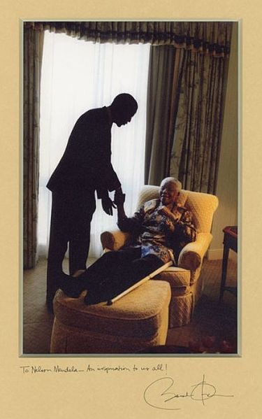 U.S. Senator Barack Obama meets for the first time with former President Nelson Mandela of South Africa, on May 17, 2005, at the Four Seasons Hotel in the Georgetown neighborhood of Washington, D.C. Photographer David Lee Katz, creator of the original photo, was on the staff of Senator Obama, with the title of Special Assistant.