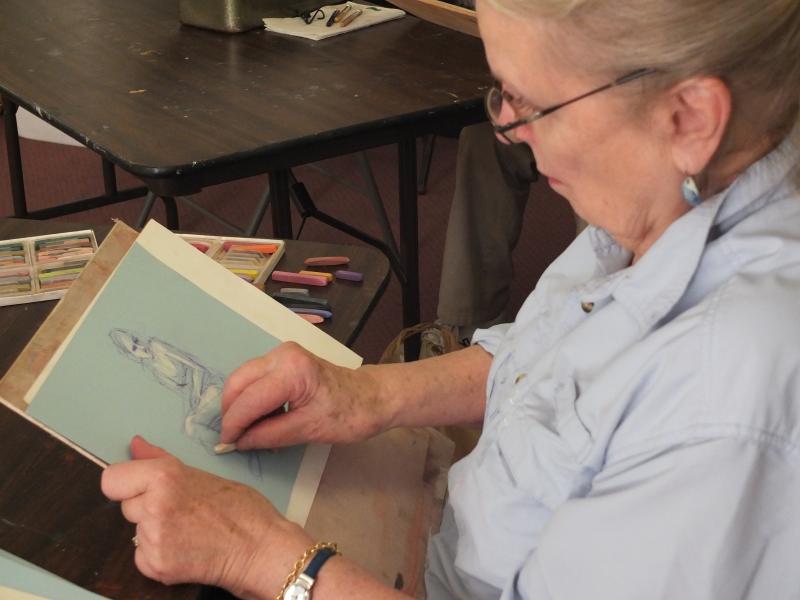 Sue Heil Kibbe adds definition to her pastel drawing of model "Annie" at Boothbay Region Art Foundation. LISA KRISTOFF/Boothbay Register