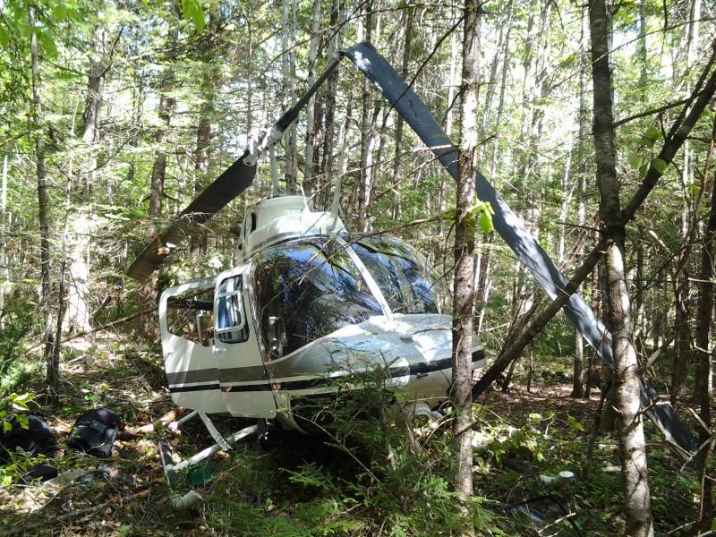 Another view of the helicopter that crashed into the woods in Whitefield on May 30. Courtesy of Kathleen Woodbury helicpoter crash