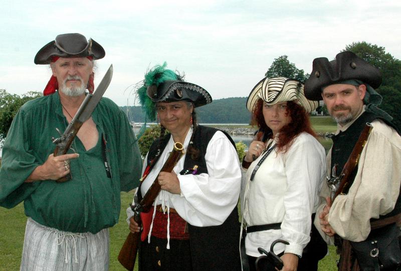 Donna Keniston and Black Rose Privateers: Donna Keniston (second from left), in her role as Capt. Ann Flynte, is flanked by members of her crew, including her husband Charles (left). They were engaging in a weapons demonstration at the 2013 Damariscotta River Pirate Rendezvous. Donna Keniston passed away on Feb. 11, 2014. Courtesy of Ellie Busby