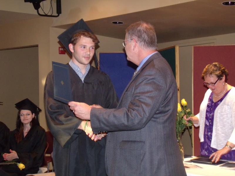School Superintendent Steven Bailey presents Samuel Margaritis with his High School Equivalency Diploma. (Adult Education Director Ellen Dickens pictured in background). Courtesy of Bonnie Merrill