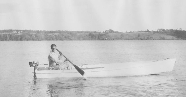 Rick Jackson (b. 1903) proudly is happy paddling his motor boat into the dock on Damariscotta Lake around 1920. Courtesy of JHS