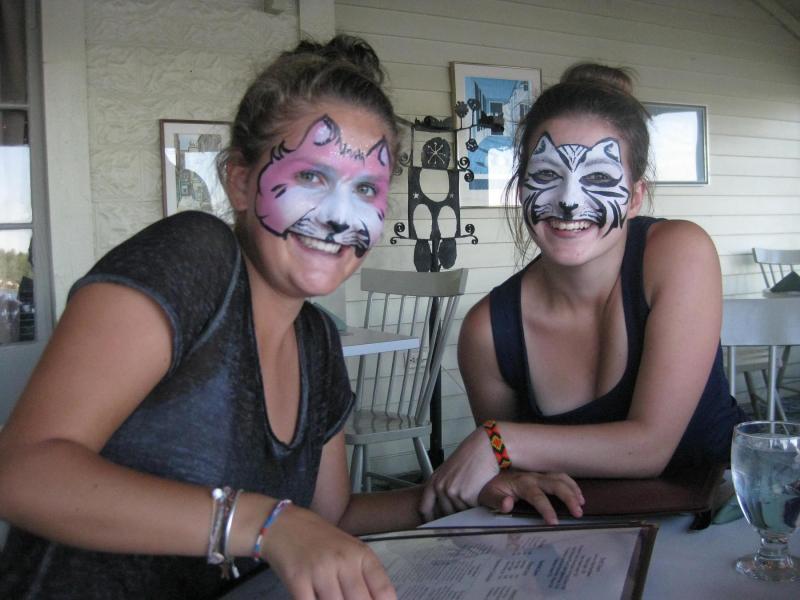 FRENCH TEENAGERS Sixtine Jadaud, left, and Camille Homassel display their painted faces after visiting the Union Fair last week. The French teens are experiencing American culture by staying with host parent Jarryl Larson in Edgecomb. Larson has been both a foster and host parent for International teenagers since 1984. Courtesy of Jarryl Larson