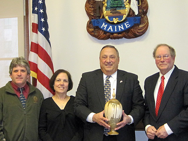 DAVID TRAHAN, left, Camille Corson, Gov. Paul LePage and Richard Corson. The governor is holding one of Corson’s lidded finial vases that was presented to him on April 28. Courtesy of Richard Corson