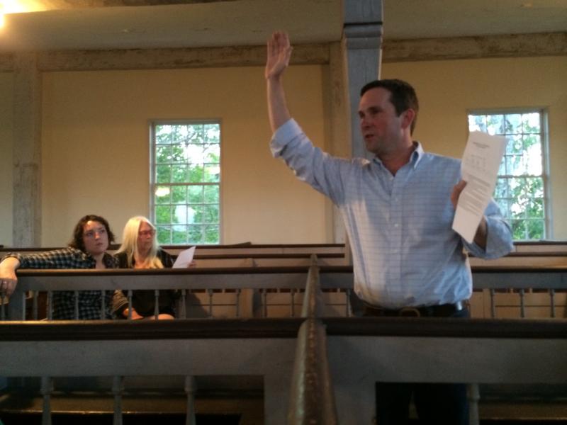 Alna Second Selectman Jonathan Villeneuve speaks at an Aug. 25 special town meeting. Its outcome ran against selectmen’s decision about the snowplowing contract. Villeneuve is holding a handout from resident, Fire Chief and former road commissioner Mike Trask outlining the deal voters went on to instruct selectmen to follow. SUSAN JOHNS/Wiscasset Newspaper Alna Second Selectman Jonathan Villeneuve