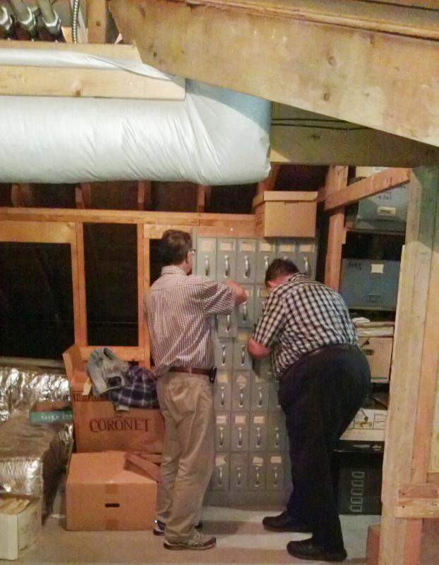 Jim Hopler, left and Jay Robbins examine documents in the courthouse attic. JANE CARPENTER/Wiscasset Newspaper