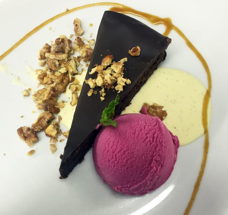 Chef Alex Tallen’s decadent dessert: flourless chocolate walnut torte with beet ice cream, salted caramel and creme anglaise, and caramelized walnuts. SUZI THAYER/Boothbay Register