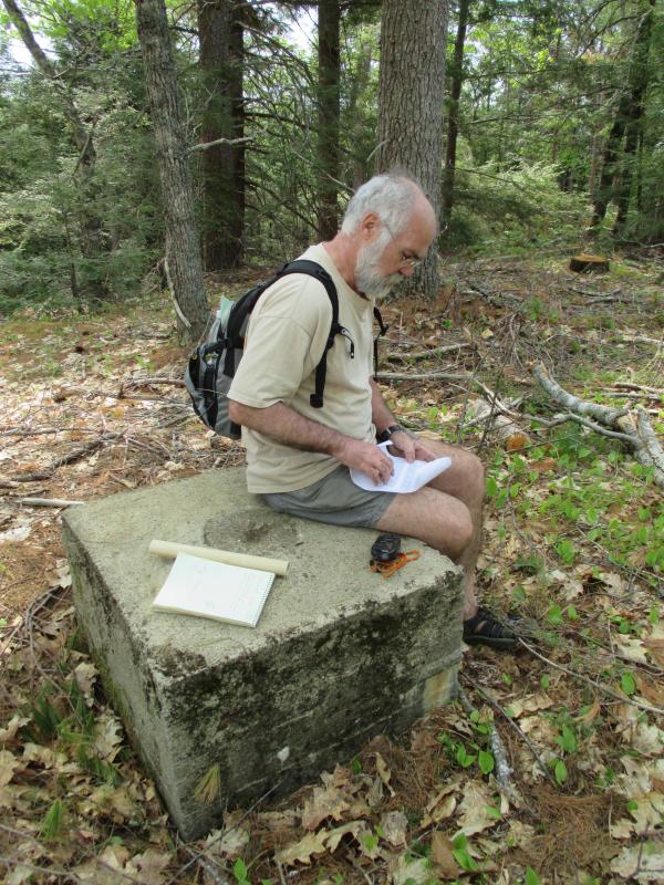 David Kepler of Woolwich enters coordinates into his GPS to help locate a surveying benchmark. Kepler has visited over a hundred geocache locations. Geocaching and benchmarking have become popular year-round outdoor activities. PHIL DI VECE/Wiscasset Newspaper
