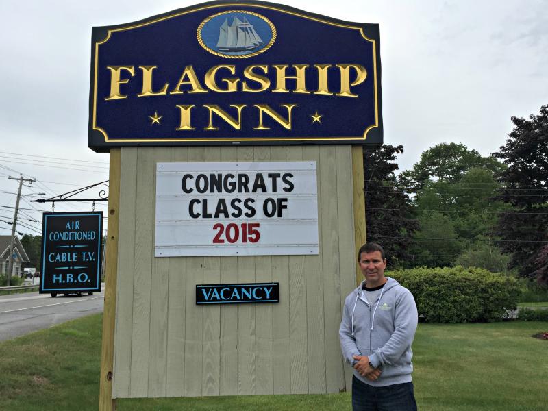 Aaron Blake stands by the sign at Flagship Inn, voted most pet-friendly lodging in all of Maine. KATRINA CLARK/Boothbay Register