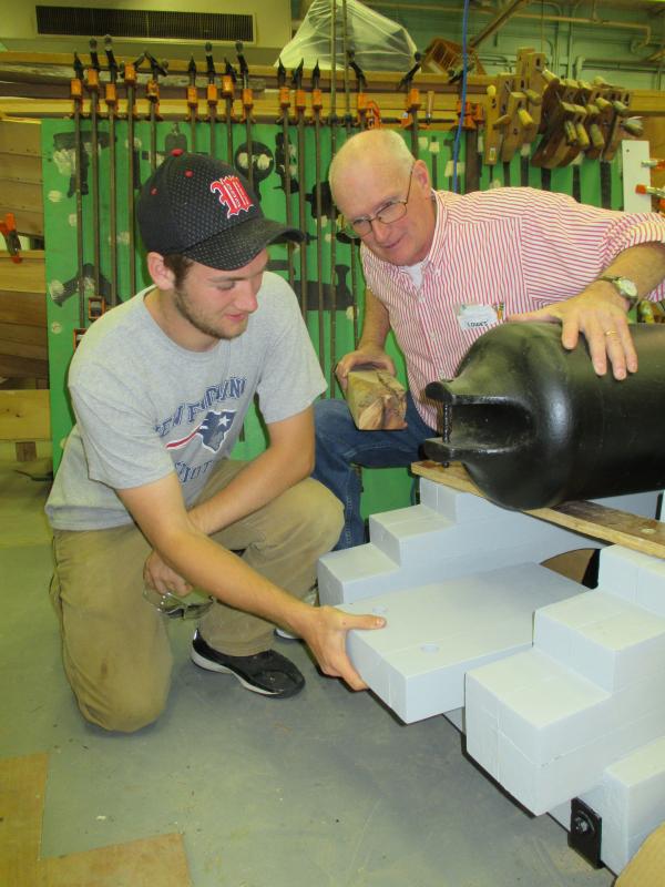 Chayse Reed and Rob Cronk, Wiscasset High School technology education teacher at work recently on Wiscasset’s cannon. PHIL DI VECE/Wiscasset Newspaper