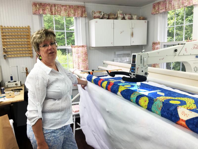 Deb Boucher in her Edgecomb studio, next to her long arm quilting machine. SUZI THAYER/Boothbay Register