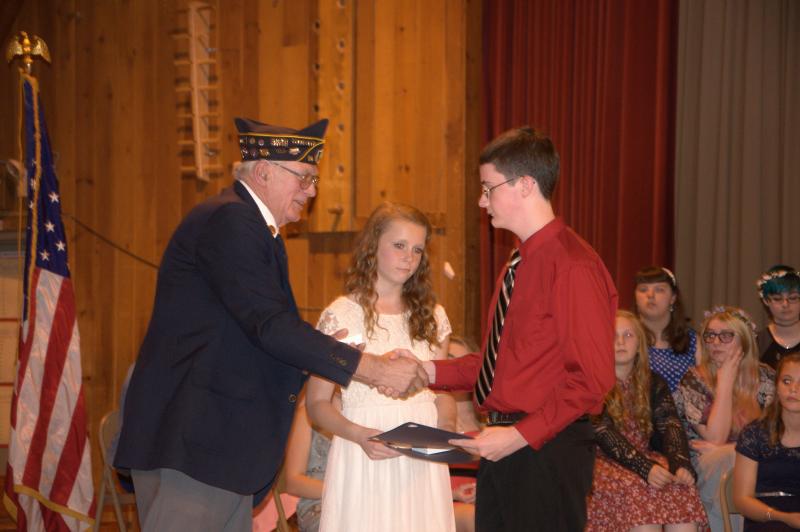 William Cossette, left, presents the American Legion Award to Natalie Corson, middle, and Matthew Smith during the last Wiscasset Middle School eighth grade graduation. BEN BULKELEY/Wiscasset Newspaper