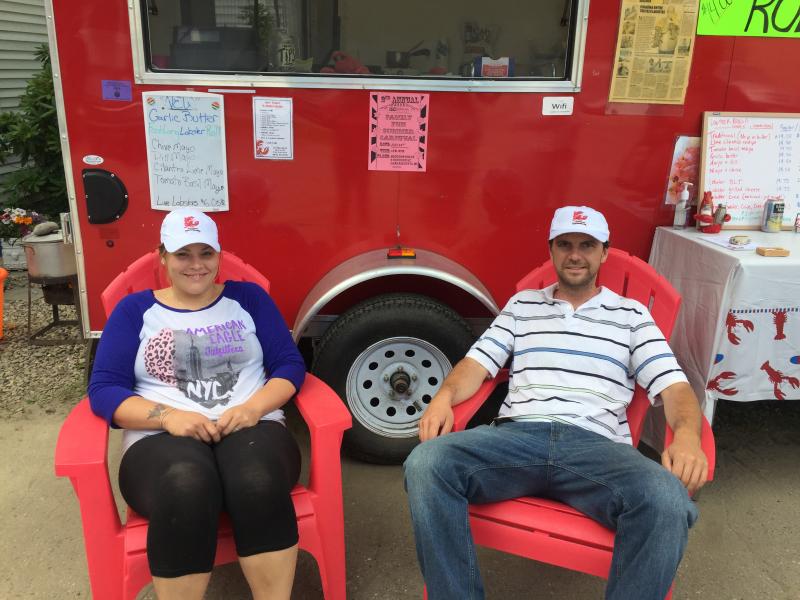 Brittany Barton and Joe Lane sit in front of the Joe Lane Lobsterman stand in Damariscotta. SUZI THAYER/Wiscasset Newspaper