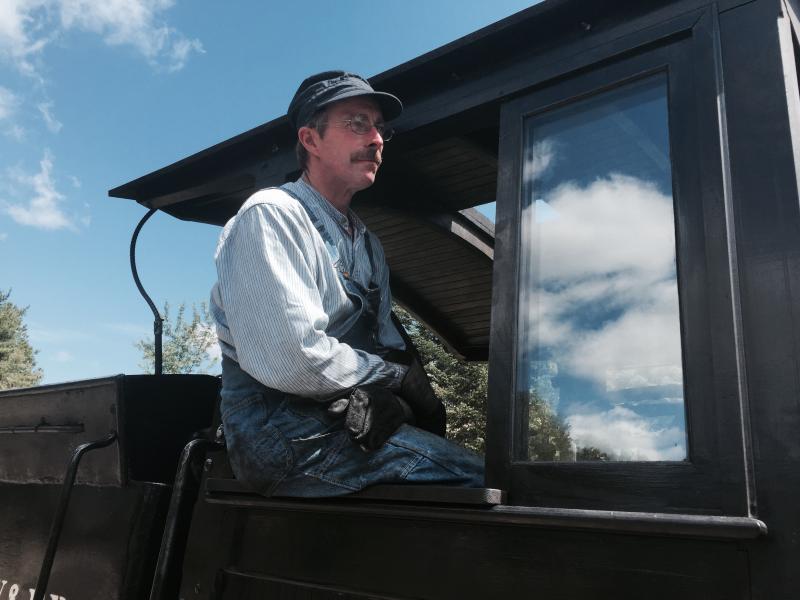 Volunteer engineer Dana Deering of Buxton looks out before the start of a train trip Aug. 9 at Wiscasset, Waterville & Farmington Railway Museum in Alna. SUSAN JOHNS/Wiscasset Newspaper Dana Deering