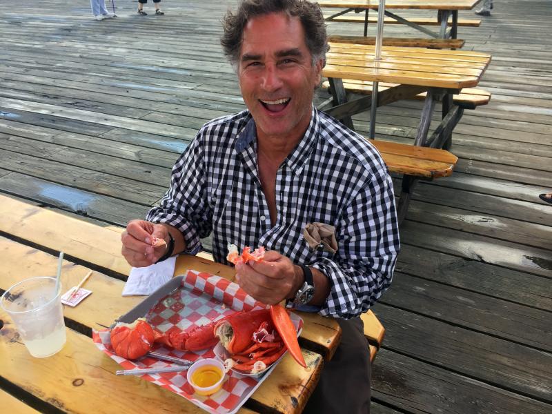 A happy customer enjoyed a lobster at Sprague’s Lobster on August 6. SUZI THAYER/Boothbay Register