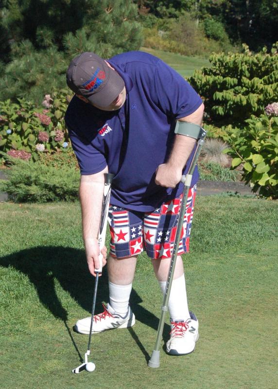 Handicapped gold medal winner Scott Allen sets up a putt. ART MAYERS/Boothbay Register