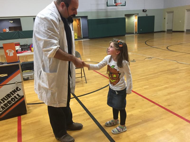 “Conjuring Carroll” Chapman and Willow Tenney, 6, of Bremen prepare for a magic trick. SUSAN JOHNS/Wiscasset Newspaper Carroll Chapman, Conjuring Carroll, Willow Tenney