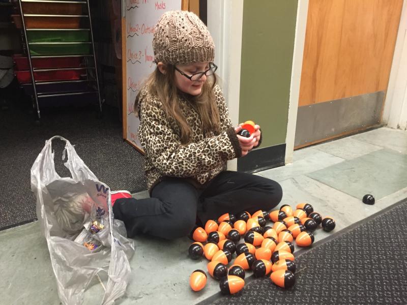 Rory Leeman, 6, of Woolwich goes through Halloween eggs collected in the hunt. SUSAN JOHNS/Wiscasset Newspaper Rory Leeman