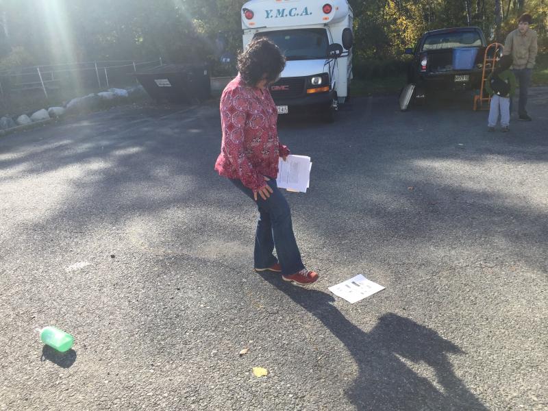 Damariscotta’s Lissette Griffin helps gather wind-blown papers at the Zombie Run. SUSAN JOHNS/Wiscasset Newspaper