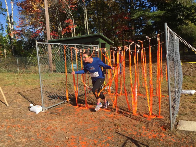Corrine Case of Brooklyn, New York, is wearing some orange with her running outfit after passing through a section of the course in the Zombie Run, Oct. 10 at CLC YMCA in Damariscotta. SUSAN JOHNS/Wiscasset Newspaper