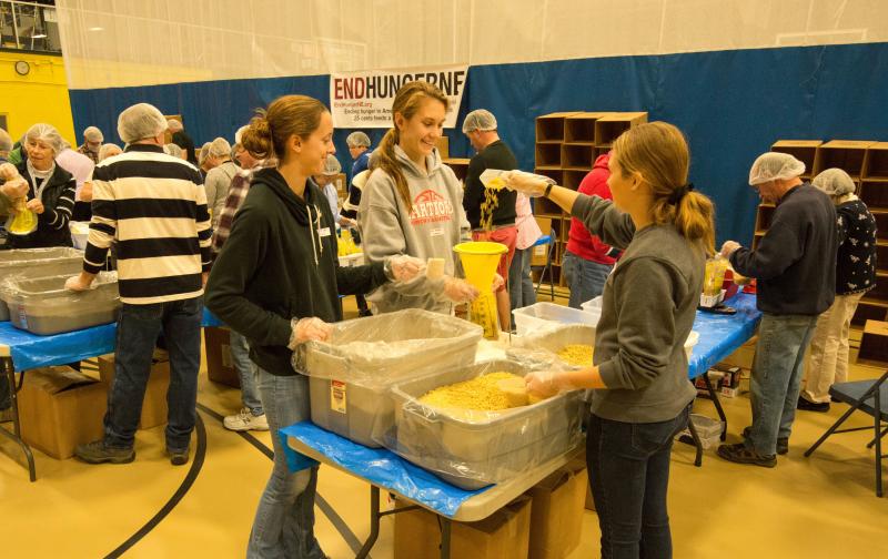 Nicole Clark, Faith Blethen and Hannah Morley of Boothbay Region High School and its Rotary Interact Club at work Sunday at the Damariscotta YMCA, helping Boothbay Rotary Club package 10,000 meals for distribution to needy area families at the "End Hunger in New England" event put on by the Boothbay Harbor and Damariscotta-Newcastle Rotary clubs. Courtesy of Steve Demeranville