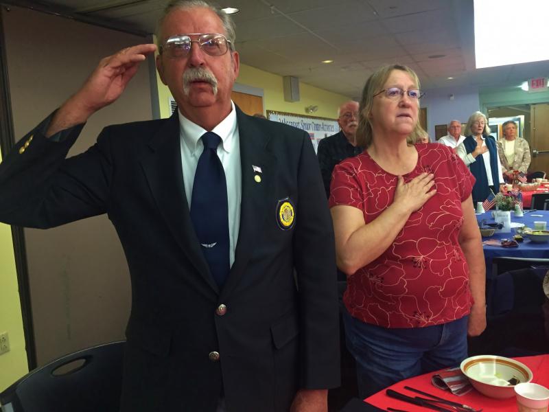 John Kennedy of Woolwich and wife Edna Kennedy pledge allegiance to the flag at a Wiscasset Senior Center supper honoring veterans Nov. 11. SUSAN JOHNS/Wiscasset Newspaper