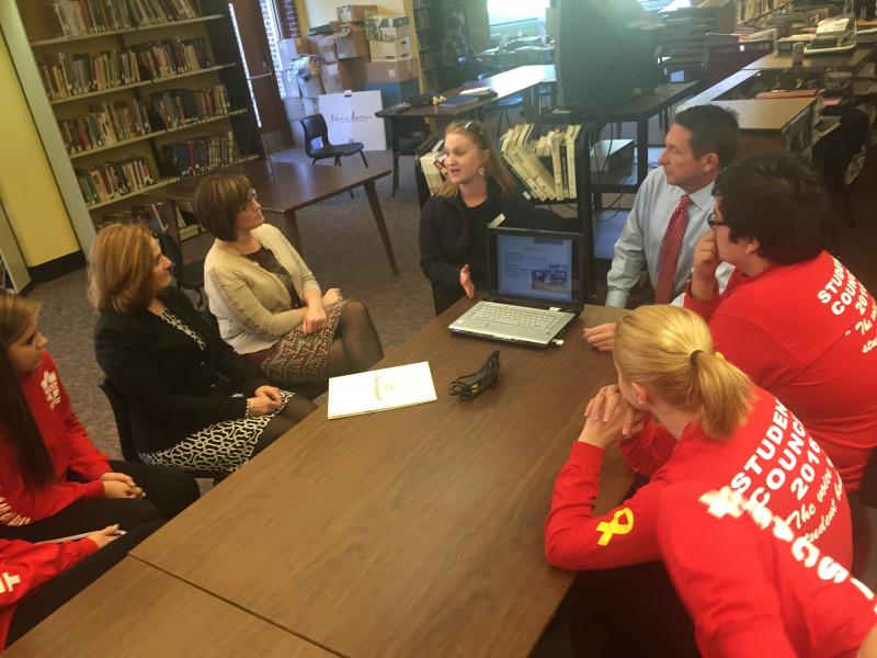 Julie Guerrette of Good Shepherd Food Bank, speaking, and, right, News 13 anchor Jeff Peterson meet with Wiscasset School Department staff and students Nov. 17 in the Wiscasset Middle High School library. SUSAN JOHNS/Wiscasset Newspaper