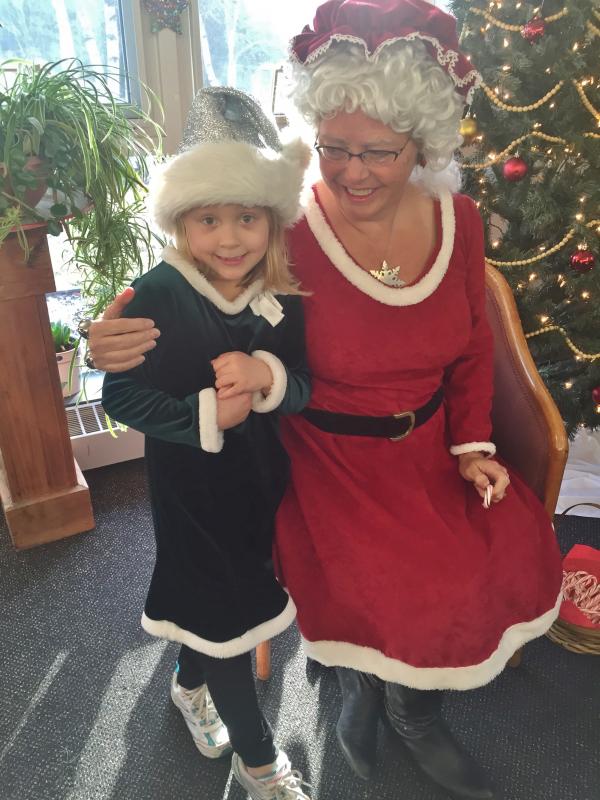 Kylee Smith, 7, of Wiscasset meets with Mrs. Claus. SUSAN JOHNS/Wiscasset Newspaper