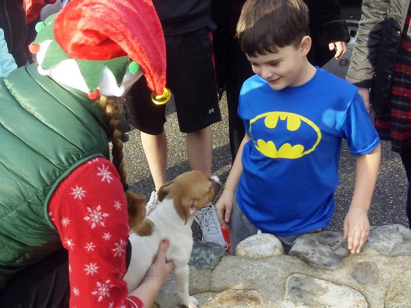 Volunteer elf Heather Straz delivers Rosie to her new bestie, Cameron Kirby, of Portland. Courtesy of Sean Kirby