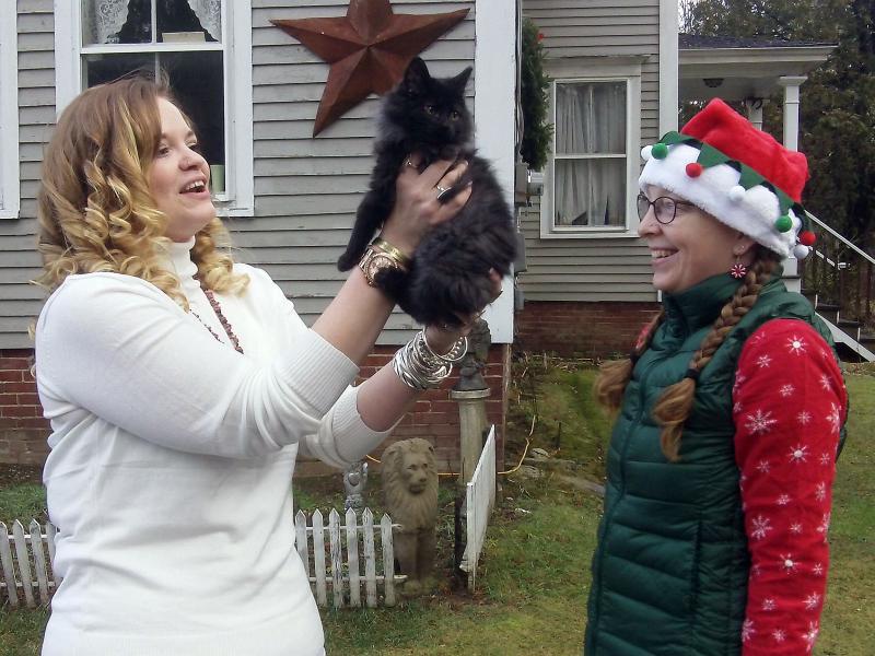 Dianna Baribeau of Topsham holds her new Christmas cat, Scooter, as Heather Staz looks on. Courtesy of Jane Siviski