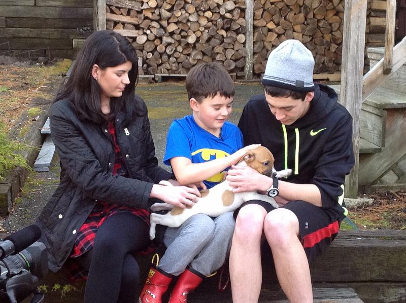 Cameron Kirby, with his sister Jacquelyn and cousin Jake, holds his new puppy, Rosie. Courtesy of Sean Kirby