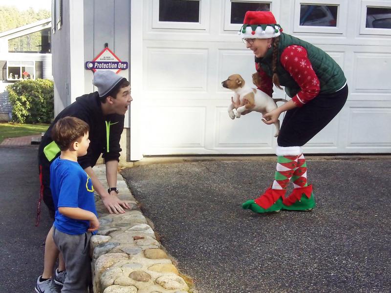 Volunteer elf Heather Straz delivers Rosie to Cameron Kirby on Christmas morning. Courtesy of Sean Kirby