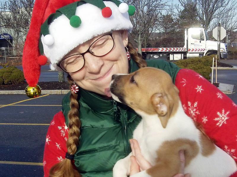 Volunteer elf Heather Straz gets a kiss of gratitude from Rosie. Courtesy of Sean Kirby