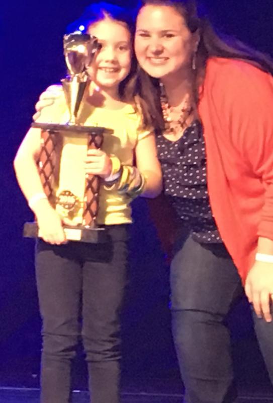 Sarah Harris and Emily Mirabile onstage receiving the award for Excellence in Acting. Courtesy of Emily Mirabile