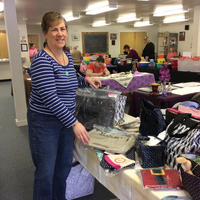 Nancy Cressey, who sells Thirty-One bags, sets up early before the show on Feb. 13. KATRINA CLARK/Boothbay Register