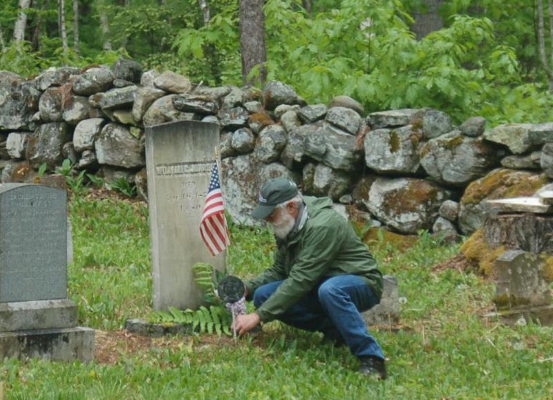 Dave Probert places flags on veterans’ graves. ART MAYERS/Wiscasset Newspaper