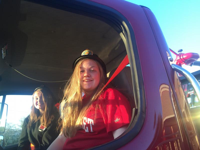 Jade Rego, 14, left, and Kateleen Trask, 14, smile from a department truck cab at Alna Fire Department’s May 18 open house at the fire station on Route 218. SUSAN JOHNS/Wiscasset Newspaper