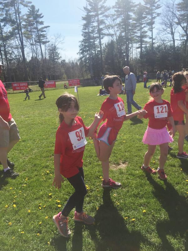 Some of Wiscasset Parks and Recreation’s running club members take part in a group stretching session before the start of the meet. SUSAN JOHNS/Wiscasset Newspaper