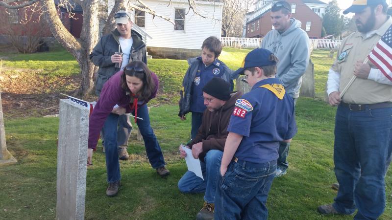 Three den leaders, a Legion member and two Cub Scouts read and confirm the lost stone is the one the Legion had been looking for. From left are Sarah Joyce, Charles Marshall, Sullivan Joyce, Neil Page, Wesley Bragan, Ben Leeman and Kurtis Bragan.Scout Hall is the white building directly behind them. Courtesy of Cub Master Susanne Smith-Pinkham of Wiscasset