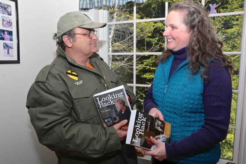 Veteran Brian Rego of Boothbay, who helped proofread Sarah Sherman McGrail’s “Looking Back, Volumes I and II,” receives the first copies of the books. Courtesy of Robert Mitchell