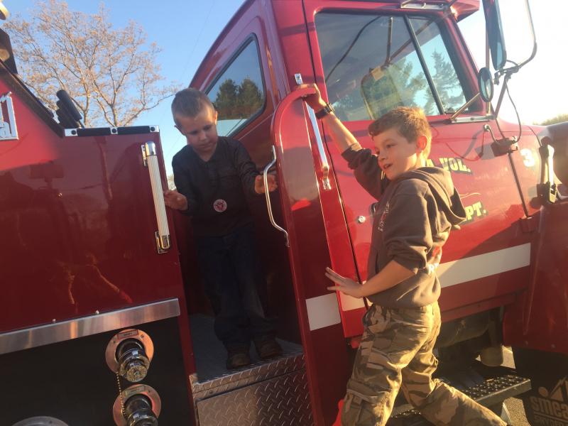 Gabriel GaNun, 5, left, and Austin Trask, 10, play tag on a fire truck during a May 18 open house at the Alna fire station. SUSAN JOHNS/Wiscasset Newspaper